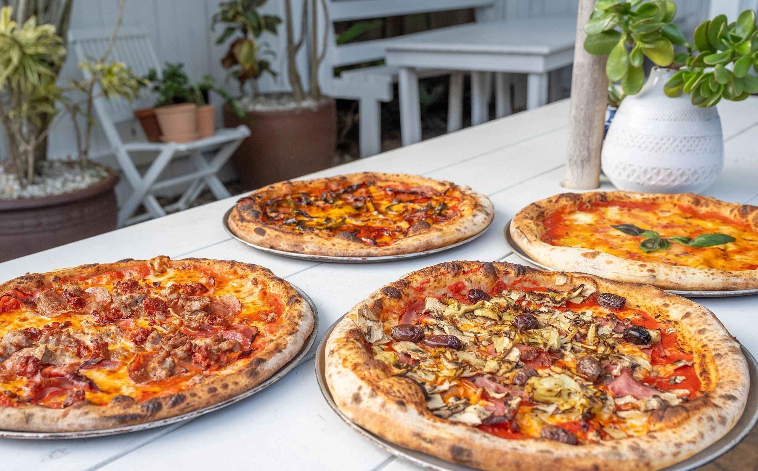 Garden pizzas on a courtyard table
